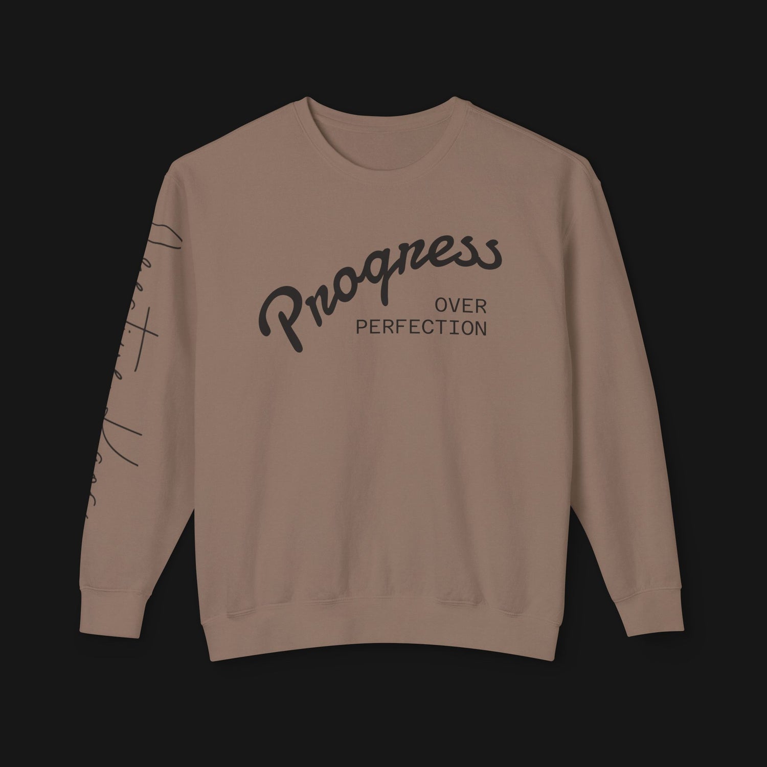 Beige sweatshirt with 'Progress Over Perfection' text on a black background