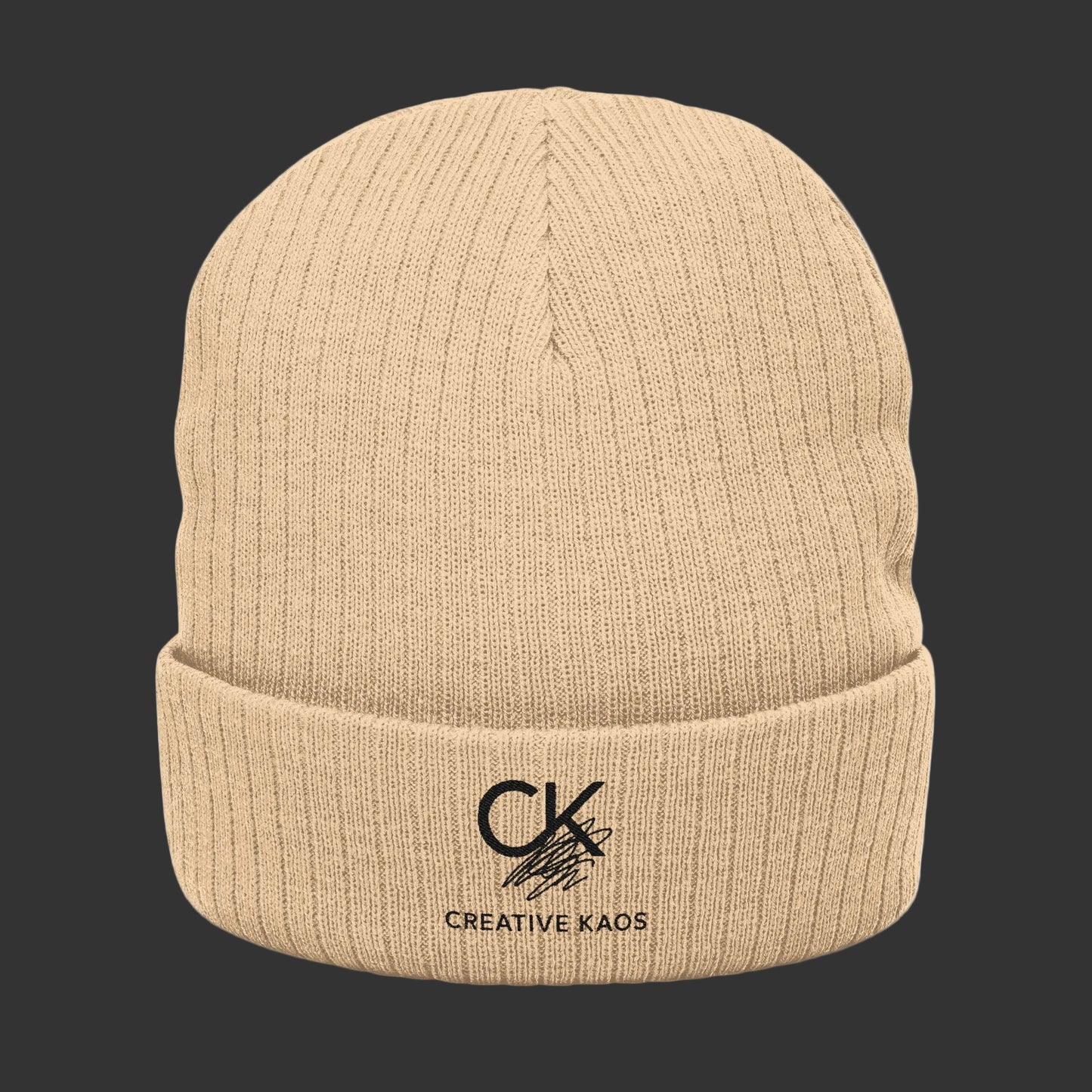 Beige knit beanie with Creative Kaos logo on a black background